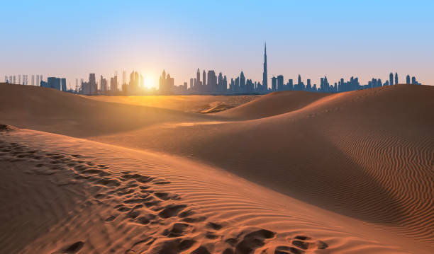 Dubai skyline over desert dunes at sunset, symbolizing opportunities for freelancers applying for a visa.