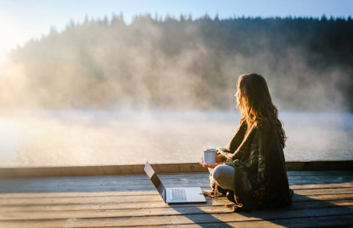 A freelancer working by a lake, illustrating the freedom offered by a freelance visa in Dubai.